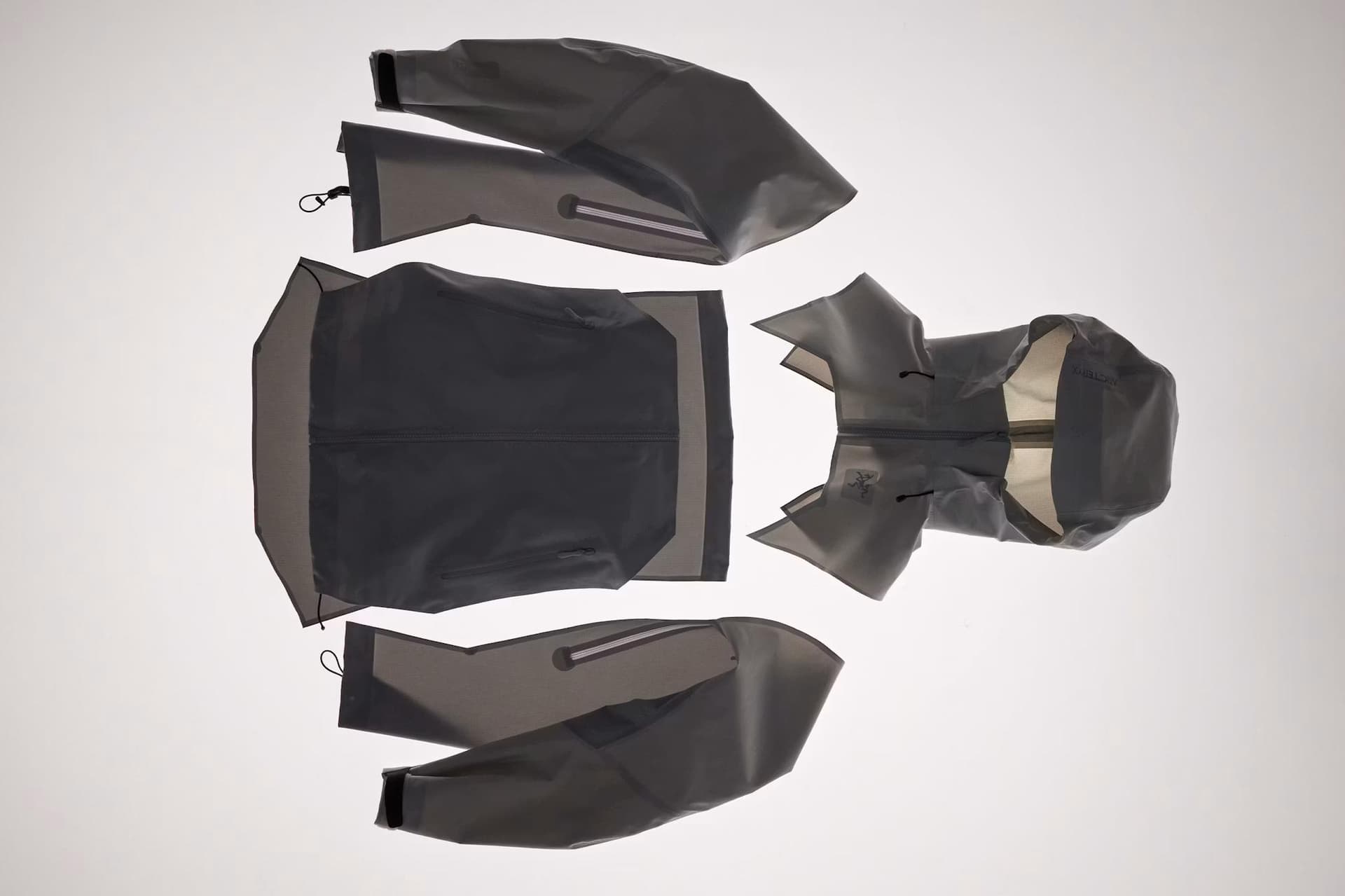 Exploded view of a grey jacket, showing torso, sleeves, and hood.
