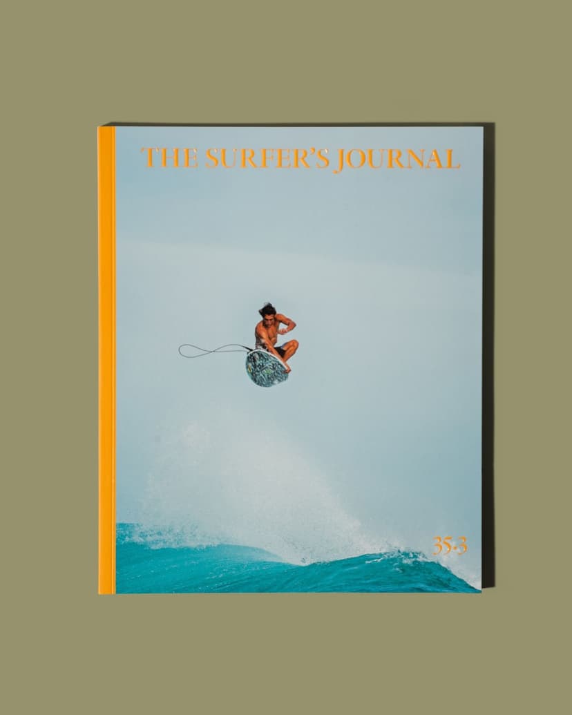 The Surfer's Journal magazine cover showing a surfer airborne above a turquoise wave.