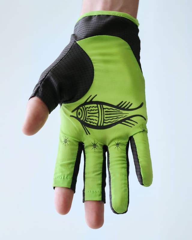 A hand wearing a bright green and black fingerless glove with a stylized black fish design on the palm.