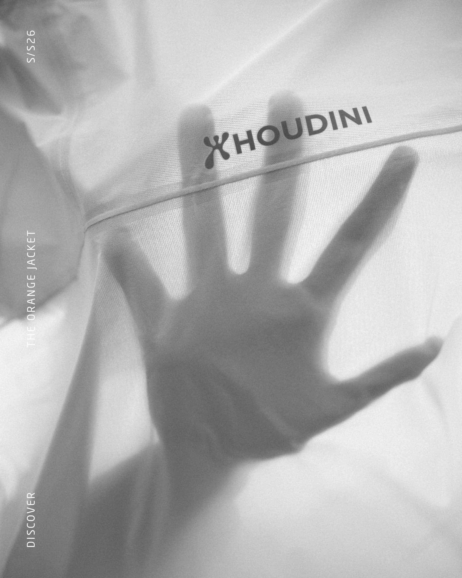 Monochrome image of a hand seen through translucent fabric with the Houdini logo.