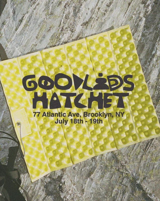 Yellow textured foam mat with black text: GOODLEDS HATCHET, 77 Atlantic Ave, Brooklyn, NY, July 18th - 19th.