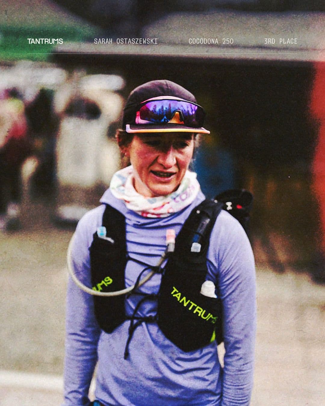 Runner Sarah Ostaszewski wearing a 'Tantrums' hydration vest, cap, and sunglasses, after placing 3rd in the Cocodona 250 race.