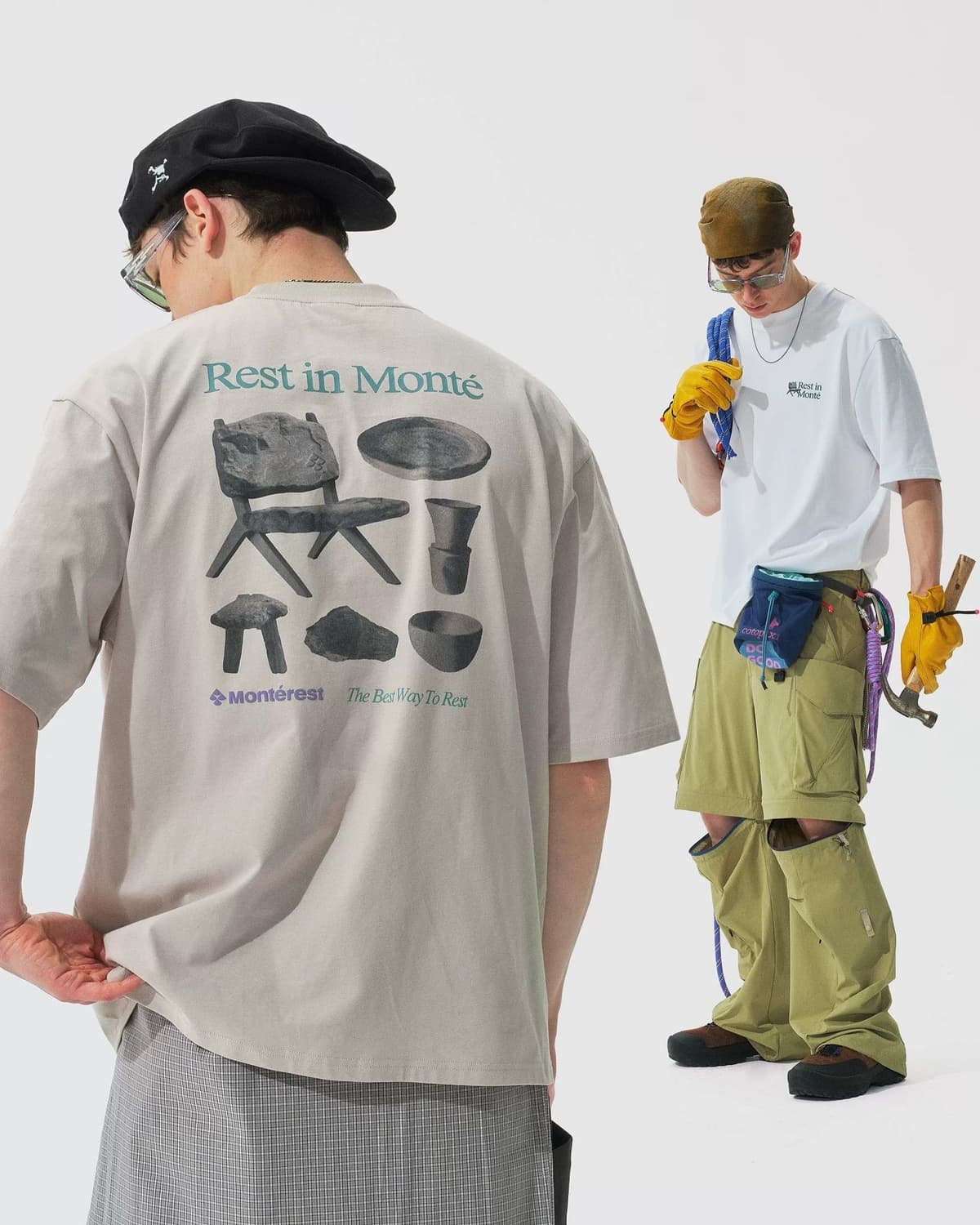 Two men model outdoor-style clothing. The man on the left wears a beige t-shirt with a back graphic reading "Rest in Monté" and images of rustic furniture. The man on the right wears a white t-shirt, olive green convertible pants with knees unzipped, and holds climbing gear.